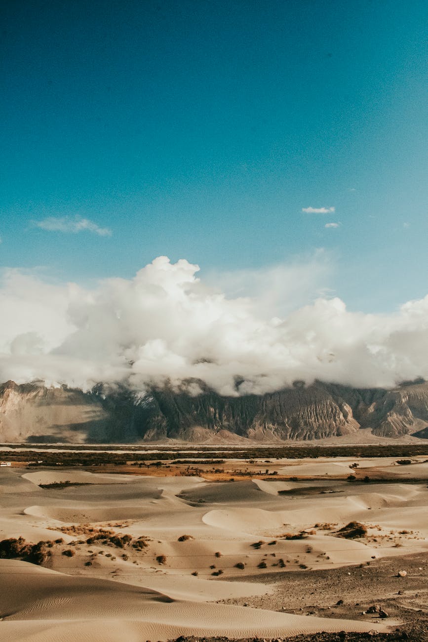 mountain covered with clouds at deserted land