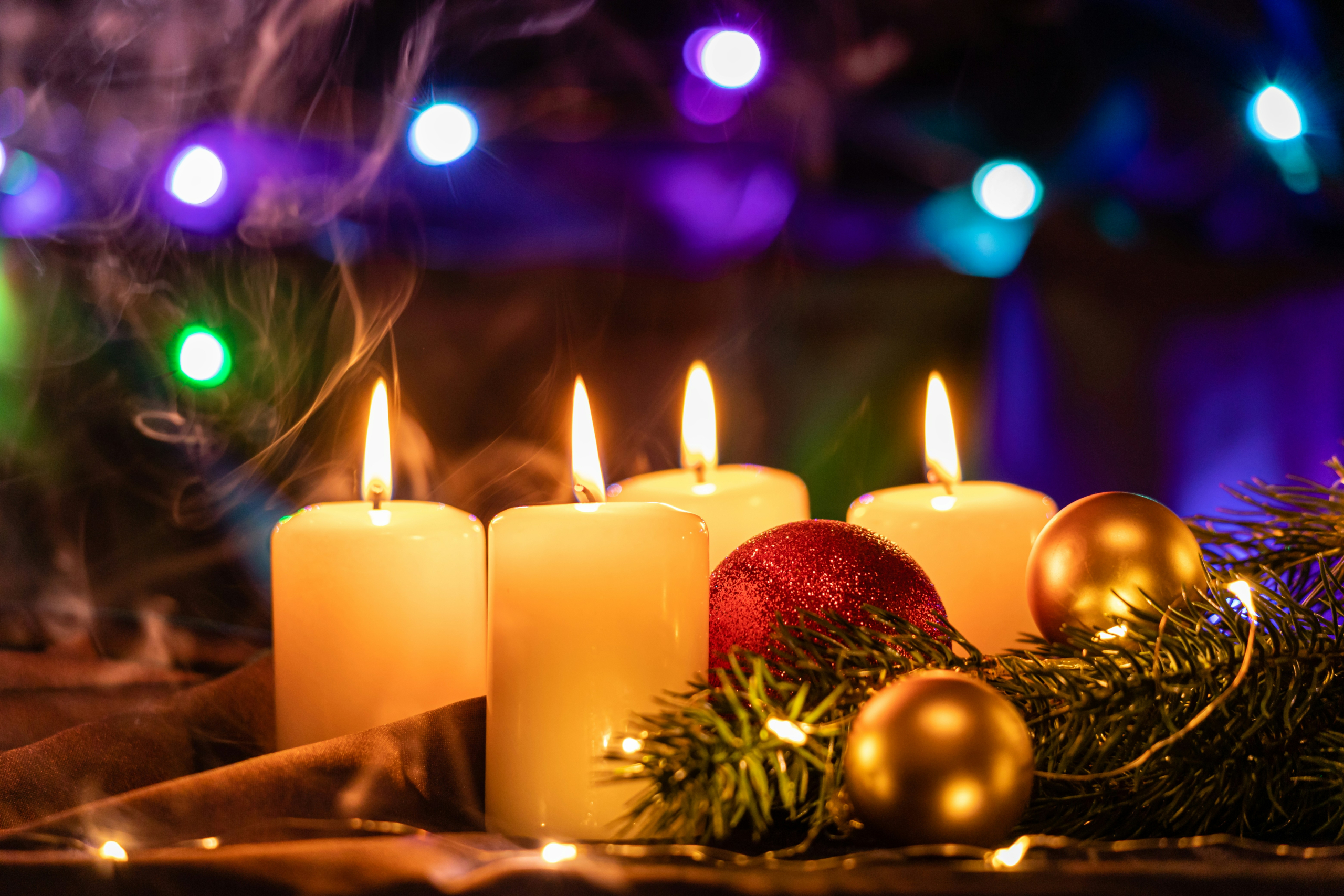 Four short white lighted candles.